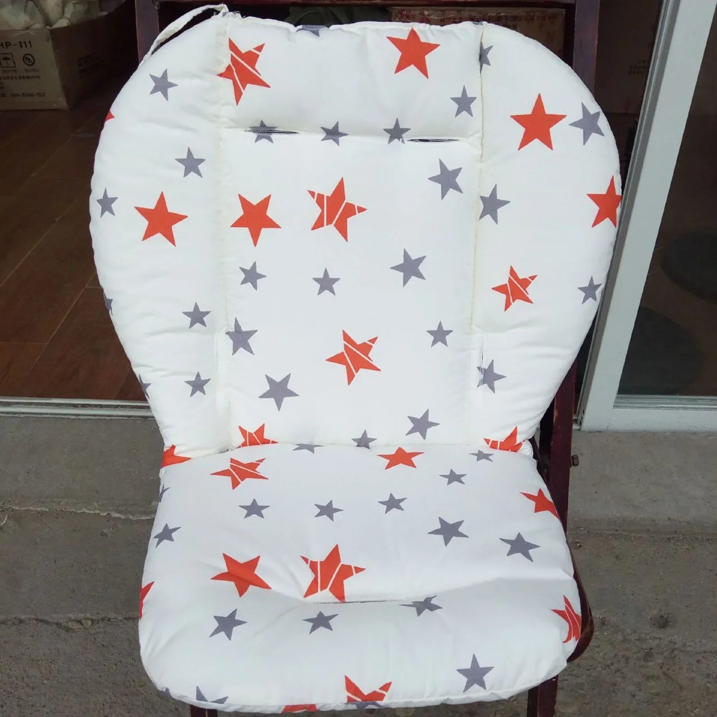Soft breathable baby cushion with cute star pattern, suitable for high chair or stroller, designed for comfort from 0-6 years.