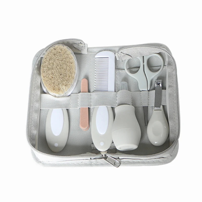 6-in-1 baby grooming set for ages 0-2 with nail clipper, brush, scissors, comb, nasal inhaler, and file in travel-friendly case.