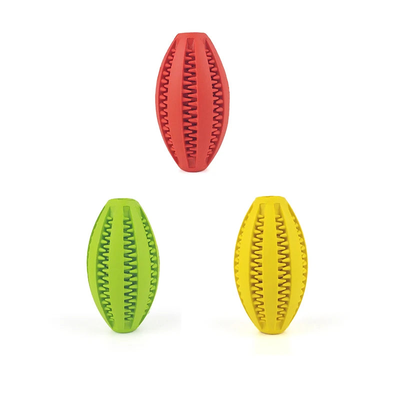 Red, green, and yellow natural rubber chew balls for dogs, designed to clean teeth and hold treats. Ideal for teething puppies.