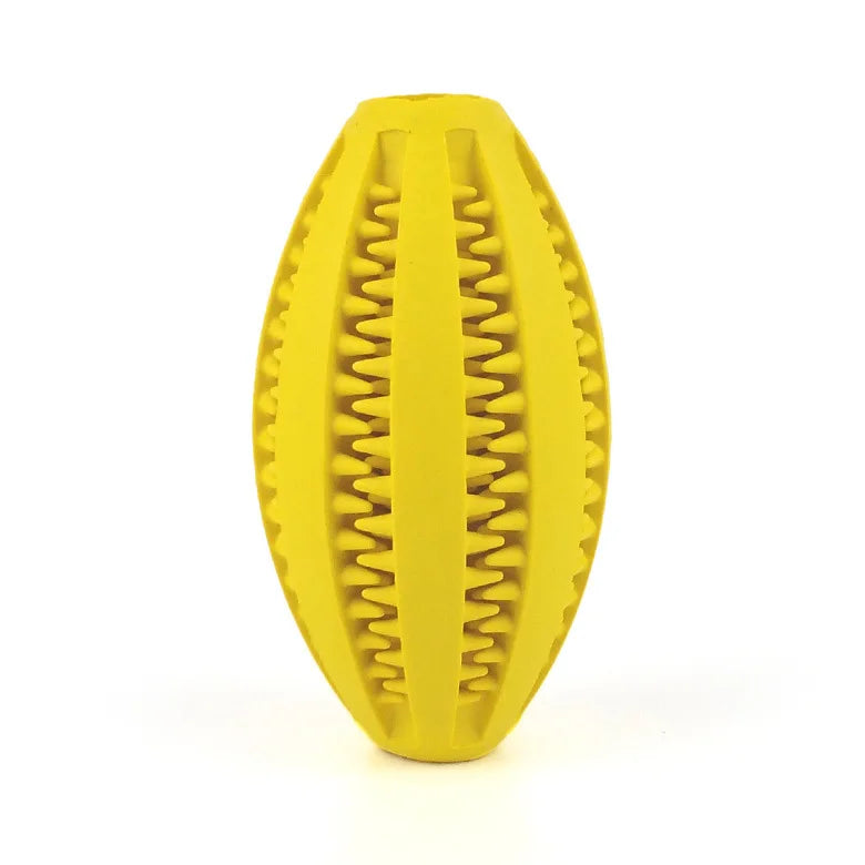Yellow natural rubber chew ball for dogs with tooth-cleaning grooves, ideal for treats and aggressive chewers.