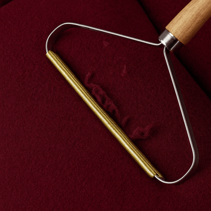 Portable Pet Hair & Lint Remover – Manual Brush for Clothes and Furniture on a red fabric surface