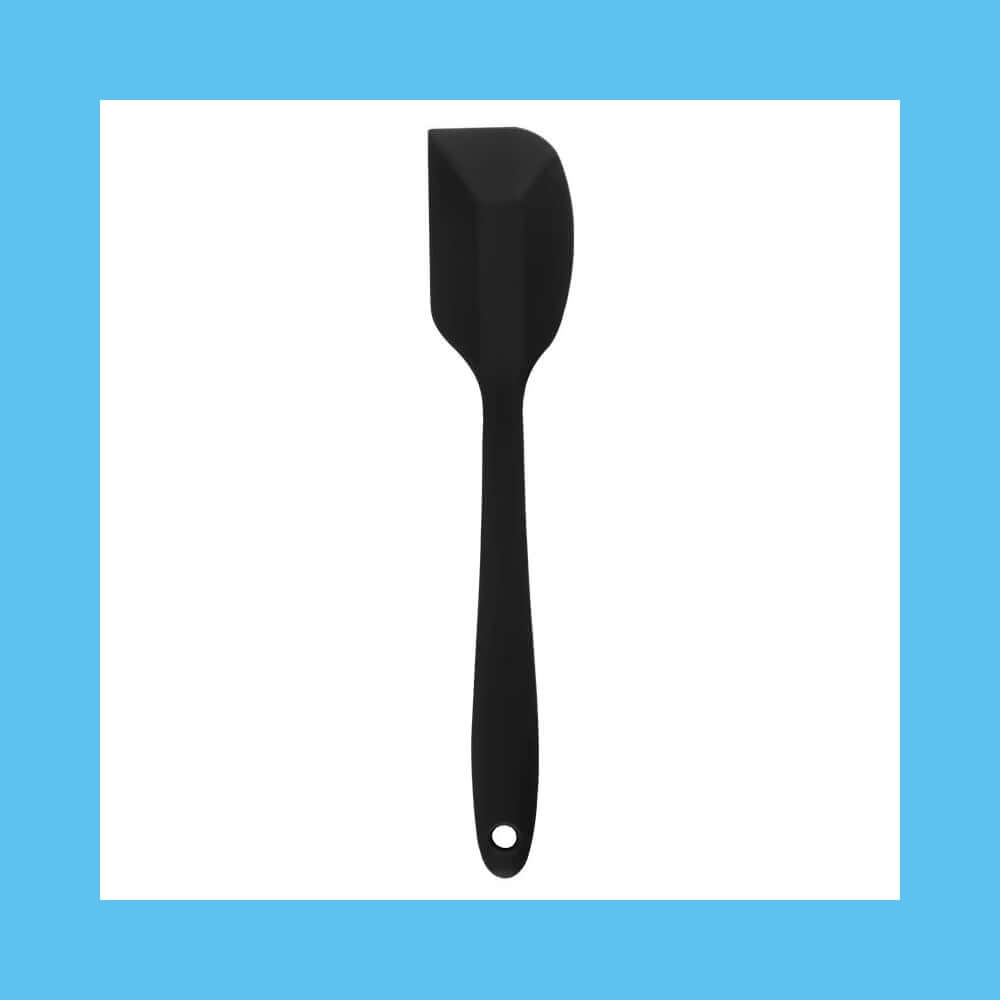 Black silicone spatula isolated on blue background