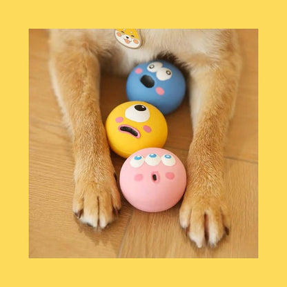 Squeaky Eyeball Dog Toy, colorful latex balls under dog's paws, fun for training and reducing boredom, perfect size for small breeds.