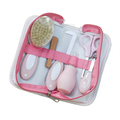 6-in-1 baby grooming kit with nail clipper, scissors, brush, comb, nasal inhaler, and nail file in pink case for ages 0-2.
