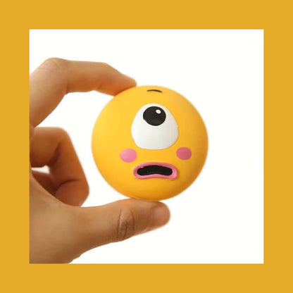 Person holding Squeaky Eyeball Dog Toy, a durable, non-toxic latex toy perfect for small breeds, playtime, and reducing boredom.