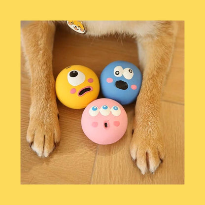 Squeaky Eyeball Dog Toy - colorful latex balls with expressive faces, durable and safe for small breeds, placed between dog's paws.