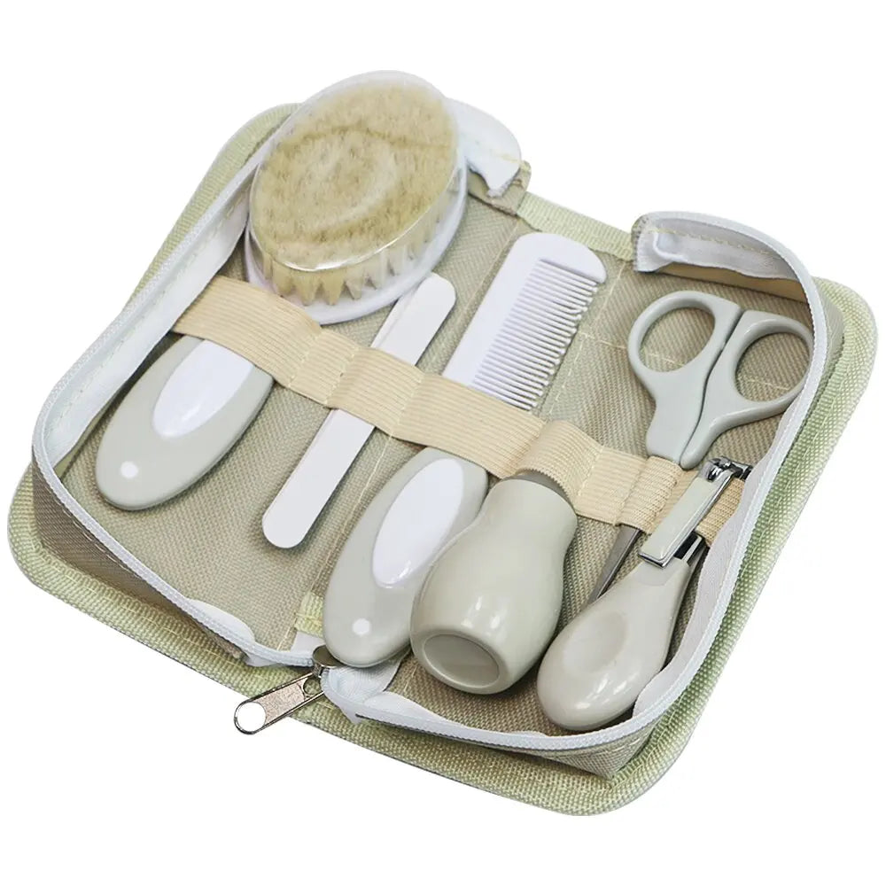 6-in-1 baby grooming set with nail clipper, scissors, soft brush, comb, nasal inhaler, and file in a zippered case.