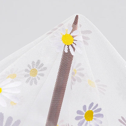 Close-up of floral-patterned mosquito netting for baby stroller sunshade and bug protection.