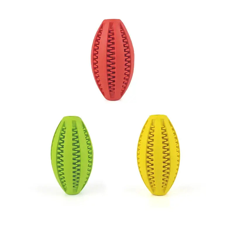 Colorful natural rubber chew balls for dogs, ideal for teeth cleaning and treat holding, in red, green, and yellow.