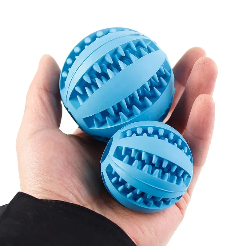 Blue natural rubber chew balls for dogs, shown in hand. Ideal for teething and treat-holding, made from durable, non-toxic material.