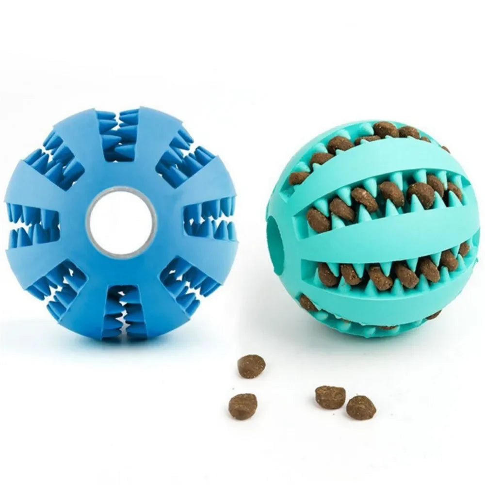 Blue and teal natural rubber chew balls for dogs, designed for cleaning teeth and holding treats, with scattered kibble.