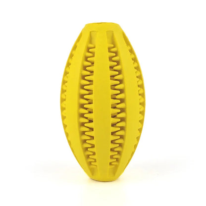 Yellow natural rubber chew ball for dogs with tooth-cleaning grooves, ideal for treats and aggressive chewers.